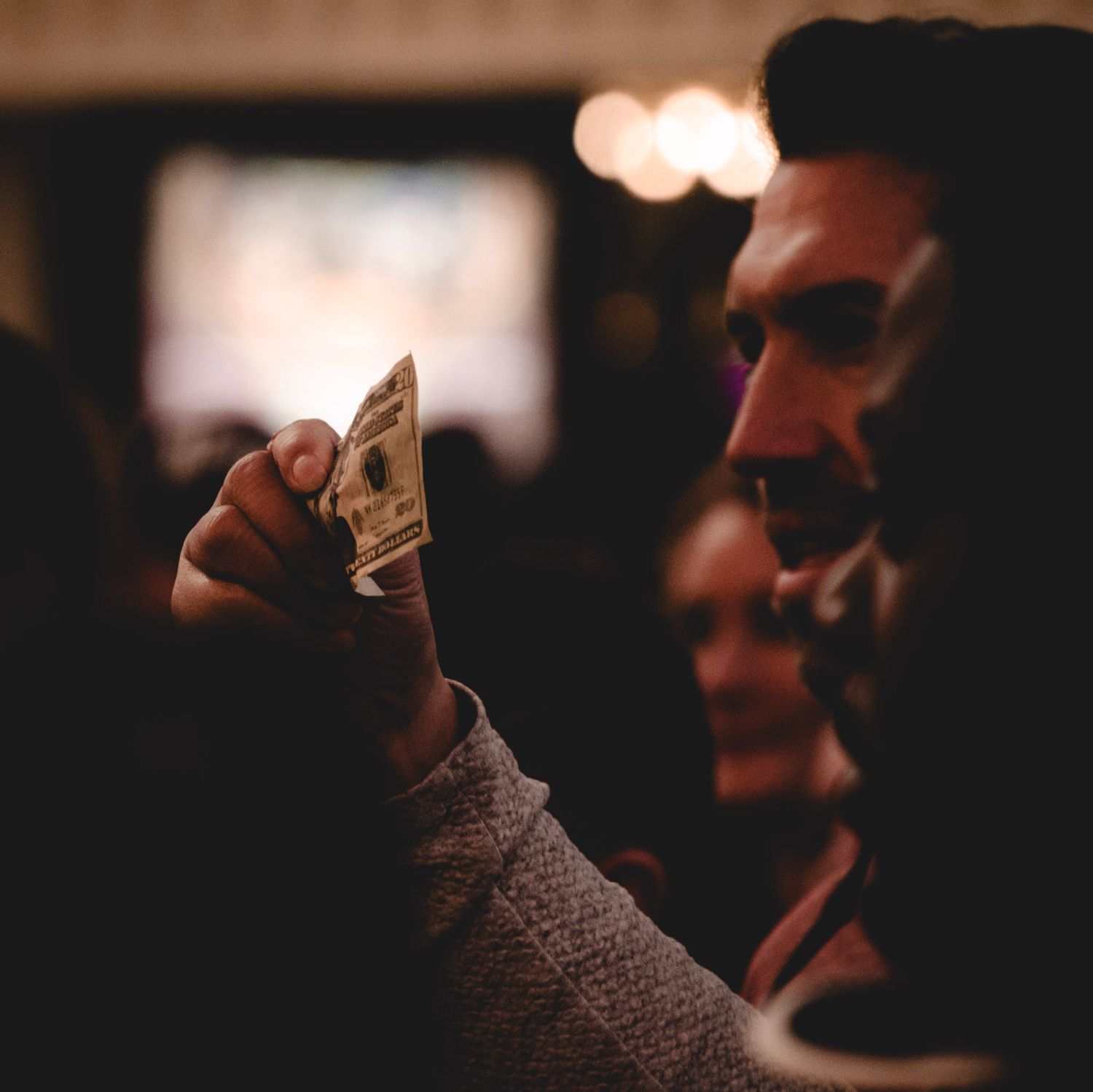 Black male, holding up a $20 Bill, on fremont street experince
