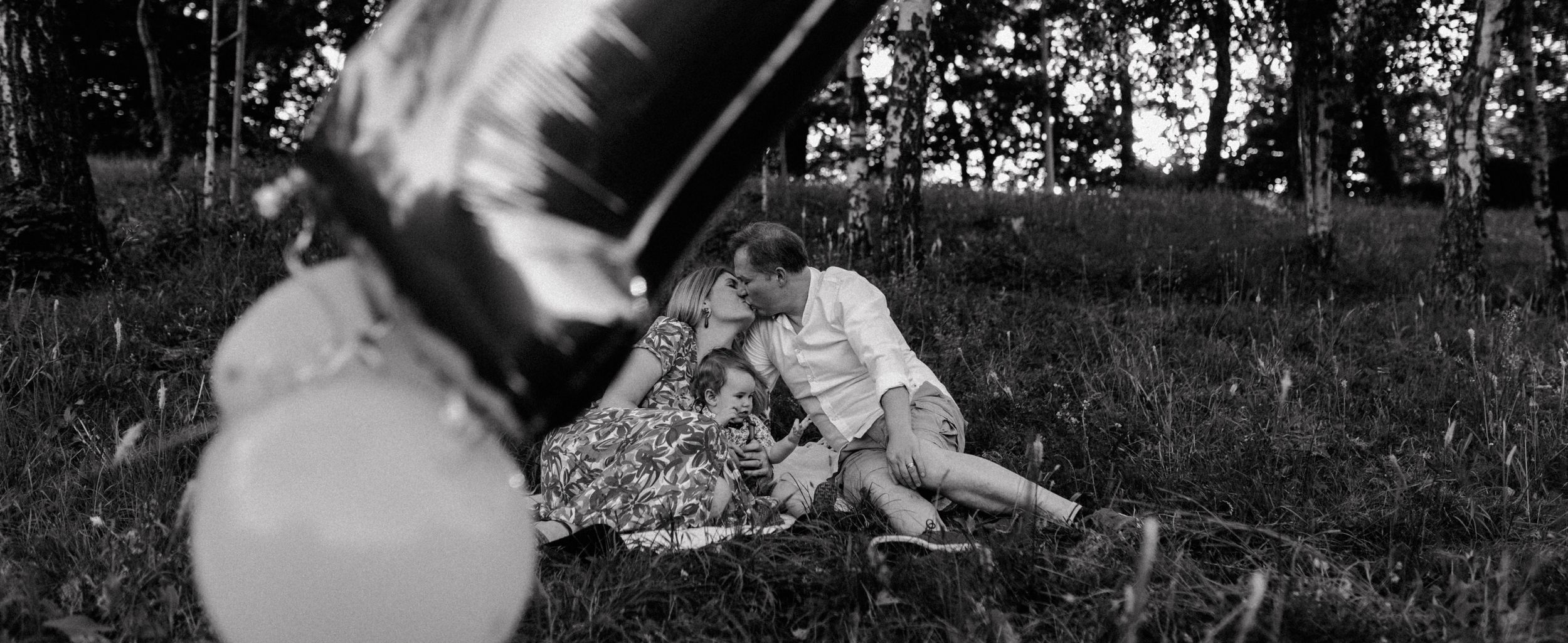 "Three happy family members sharing smiles on a cozy blanket, capturing a warm and loving moment in Jelenovac.