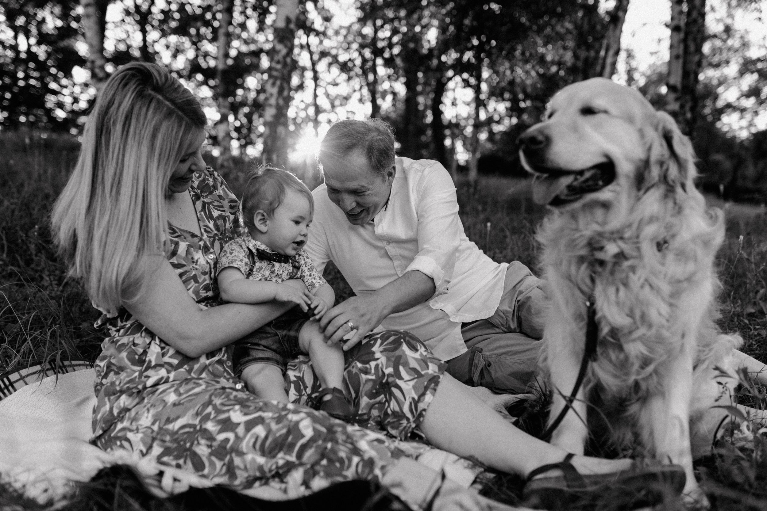 Parents with their baby and family dog at Jelenovac, capturing a first birthday celebration.