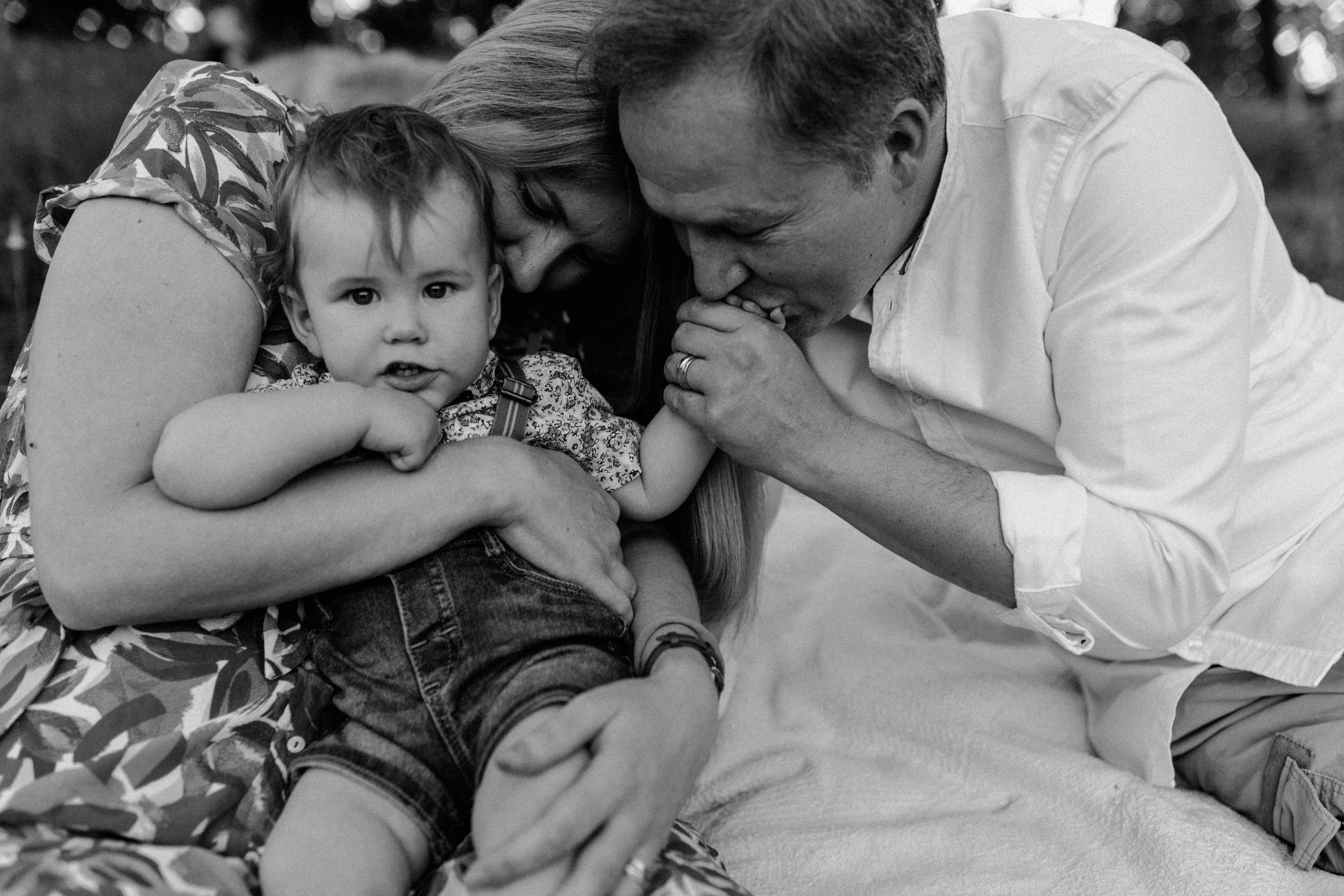 Candid black and white family portrait showing intimate moment of togetherness.