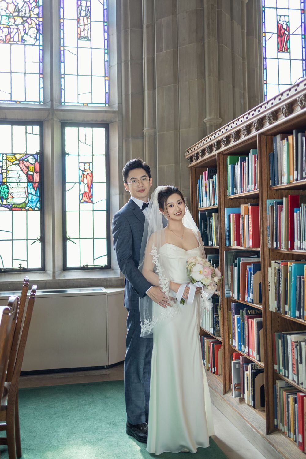 Wedding photo session in a library with stained glass windows and green carpeting.