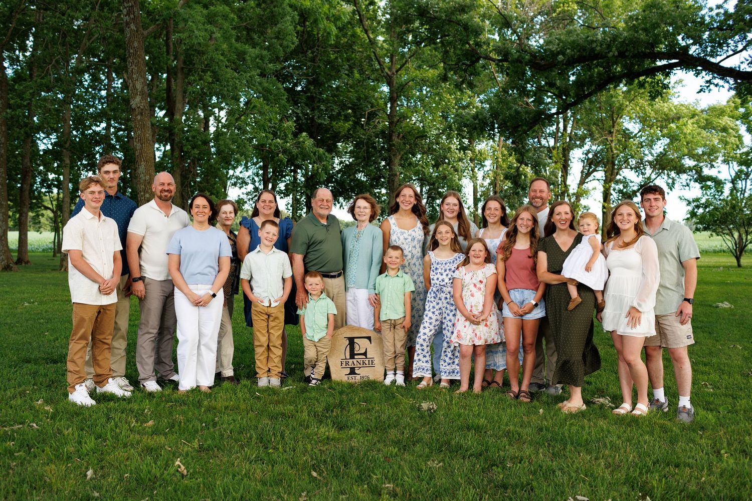 An extended family picture wearing summer clothes and smiling in front of Lake Mattoon.