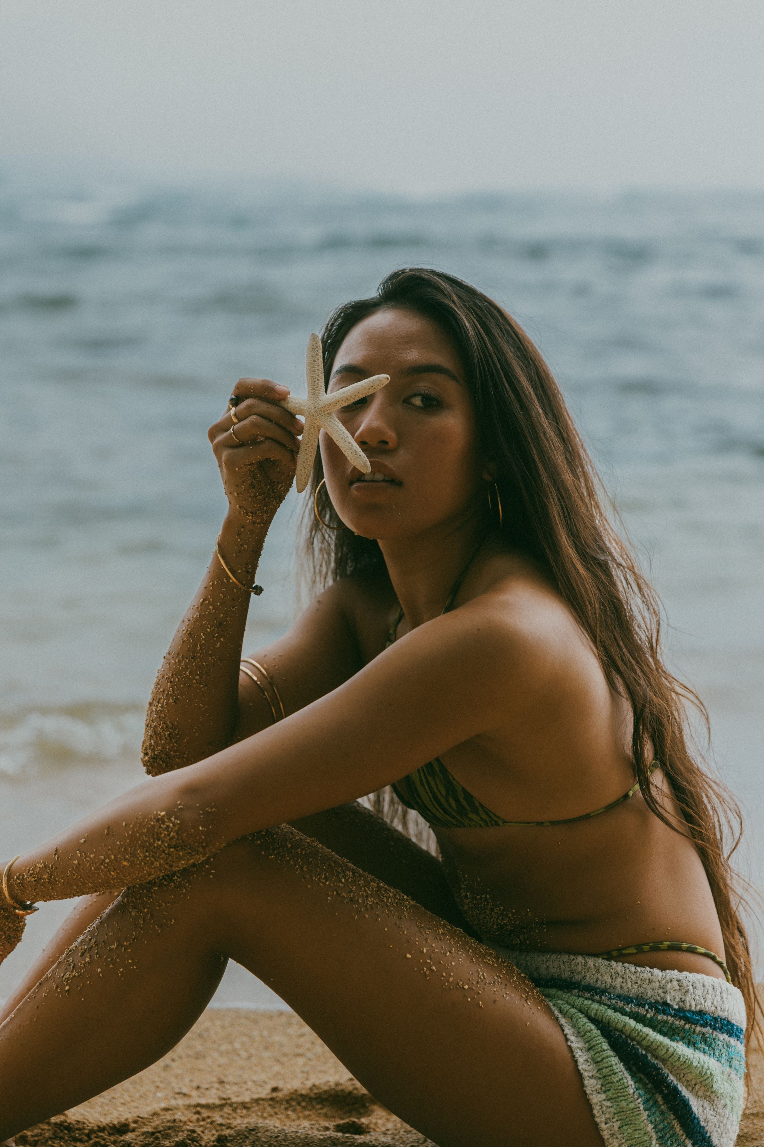 Artistic sequence of beach portraits with sparkly textures and ocean backdrop.