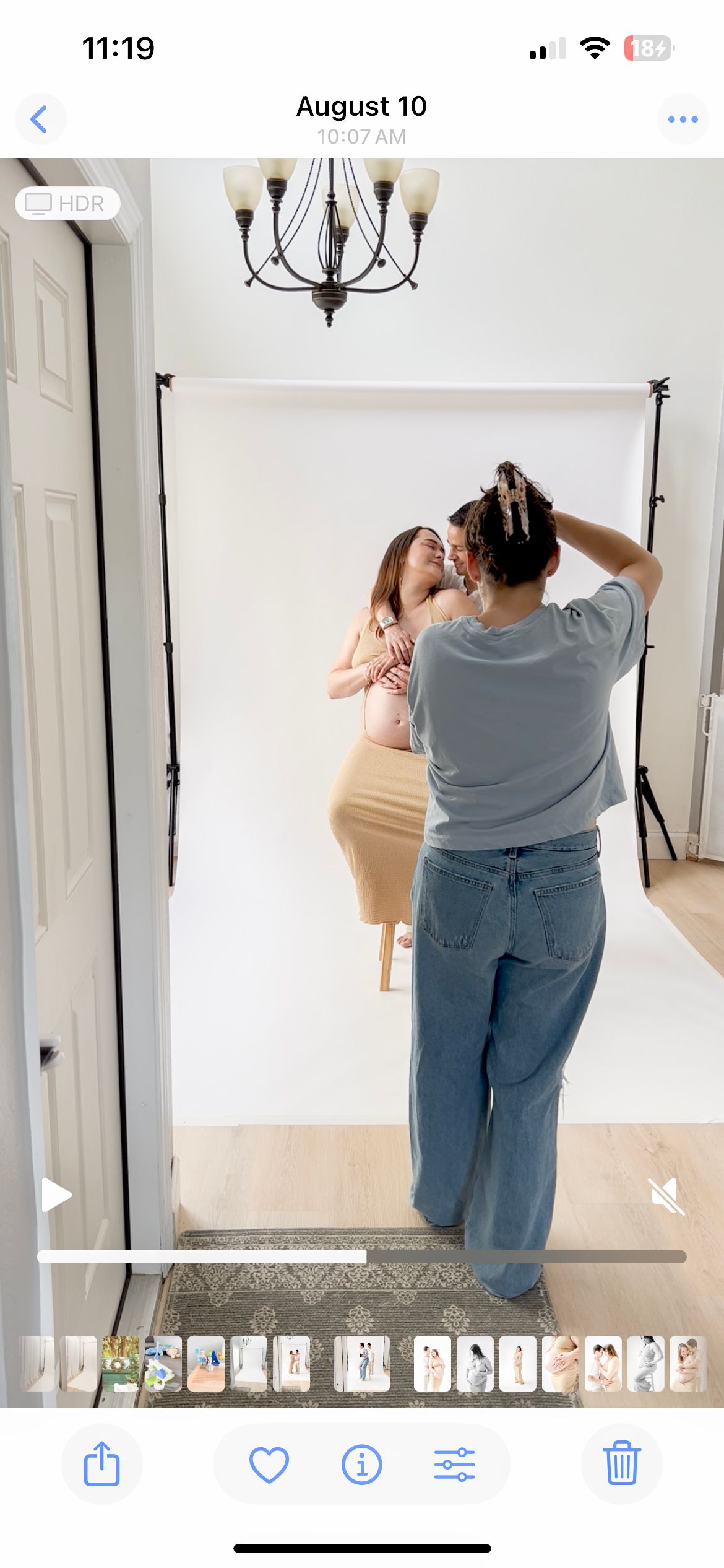 Behind-the-scenes photography studio setup with photographer working.