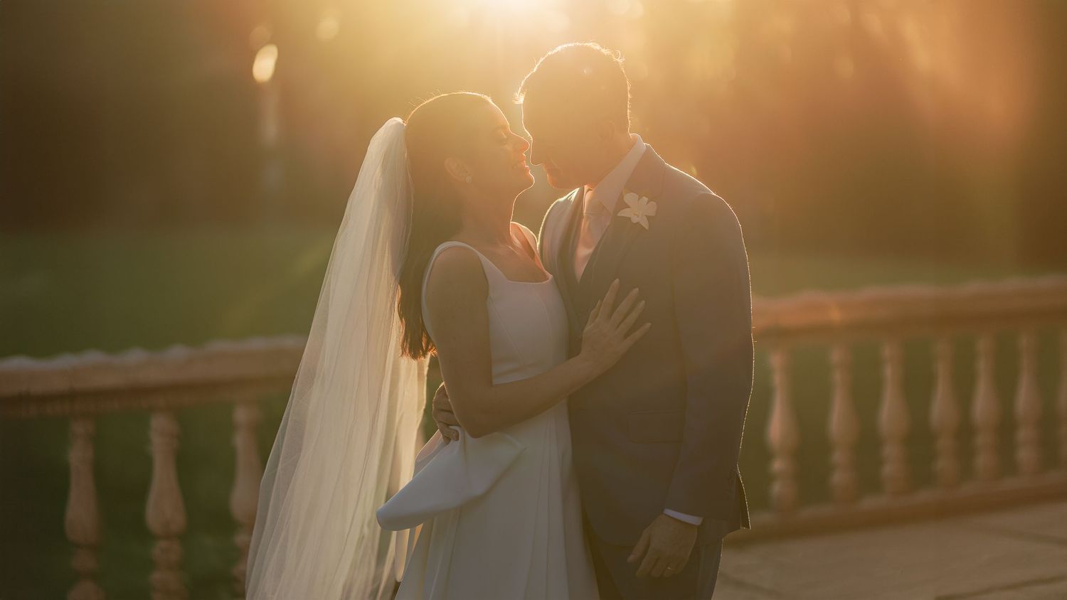 Golden hour wedding portraits captured during sunset with romantic backlighting.