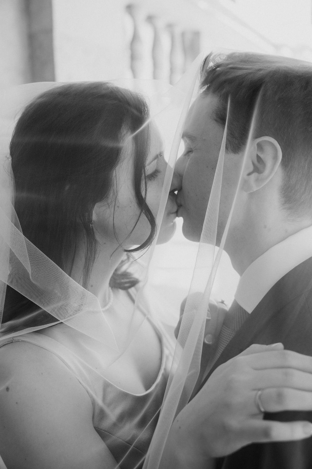 A series of black and white photos showing tender romantic moments between two people in close proximity.