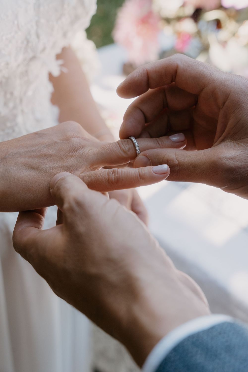 A sequence of close-up shots showing hands exchanging wedding rings during a marriage ceremony.