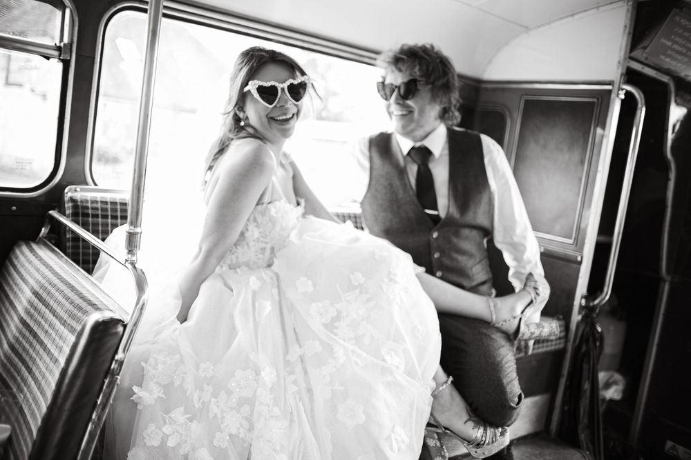 Retro-styled couple share joyful moment inside vintage vehicle.