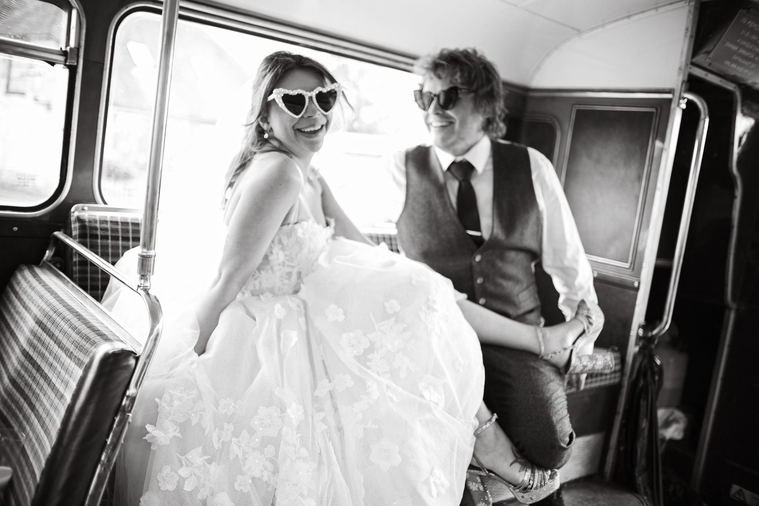 Retro-styled couple share joyful moment inside vintage vehicle.