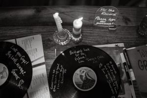 Vinyl records and candles arranged as wedding guest book alternative.