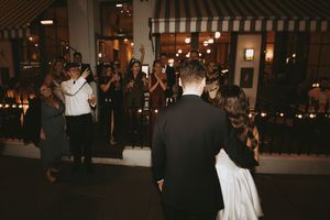 A sequence of wedding reception photos showing guests dancing and celebrating in a dimly lit venue.
