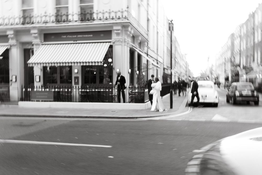 Black and white urban cityscape showing empty streets with historic architecture and storefronts.
