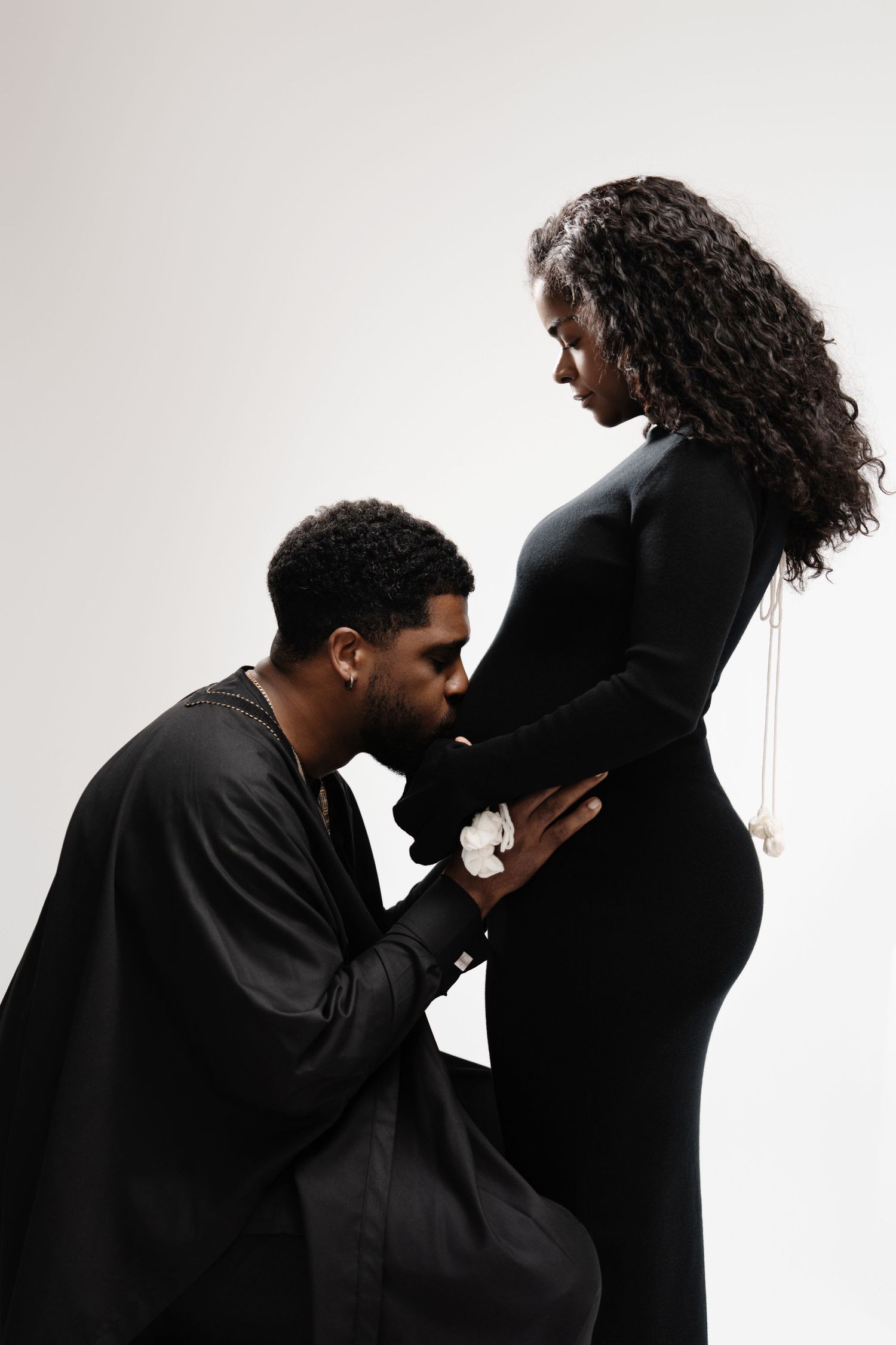 Two figures in black silhouette against white background shown in artistic sequence of intimate poses.