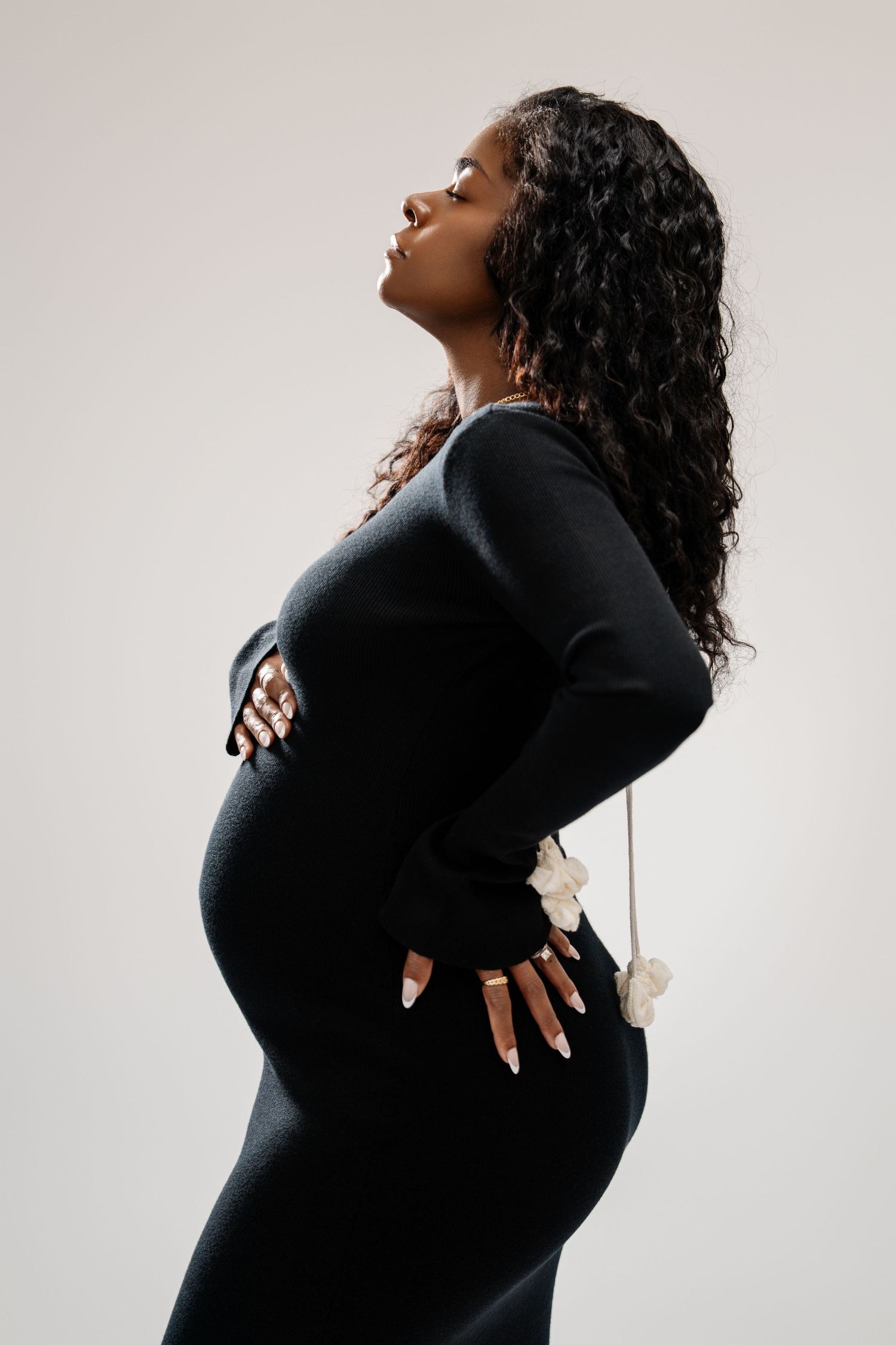 A series of artistic profile portraits showing a woman in black against a light background, captured in expressive poses.