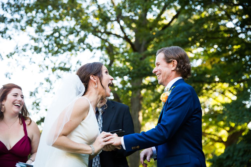 Happy couple laughs together during outdoor photo session.