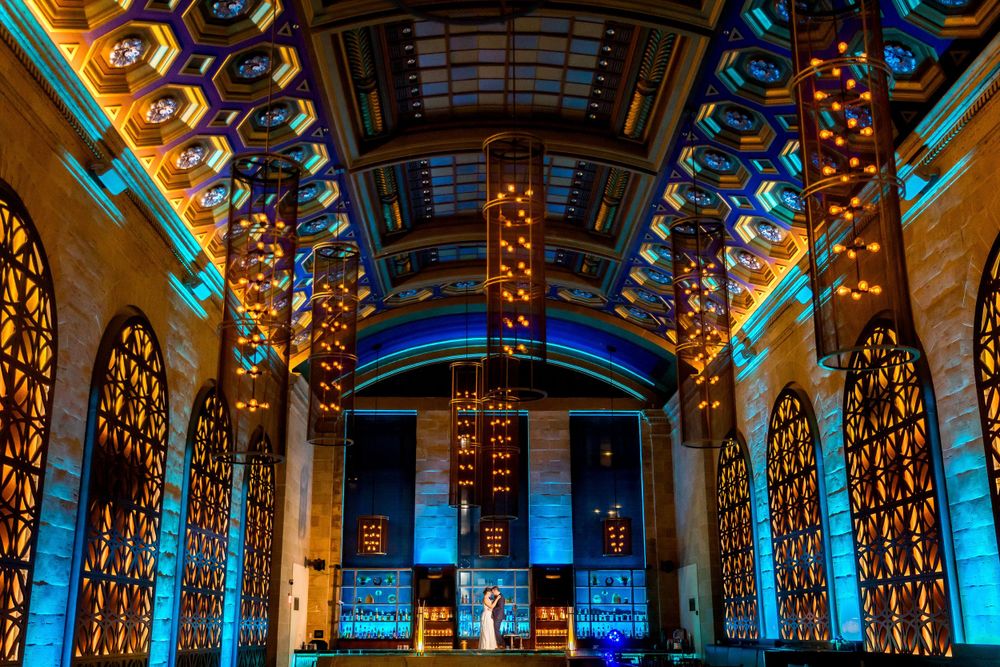 Elegant ballroom with ornate blue lighting and dramatic architectural details.