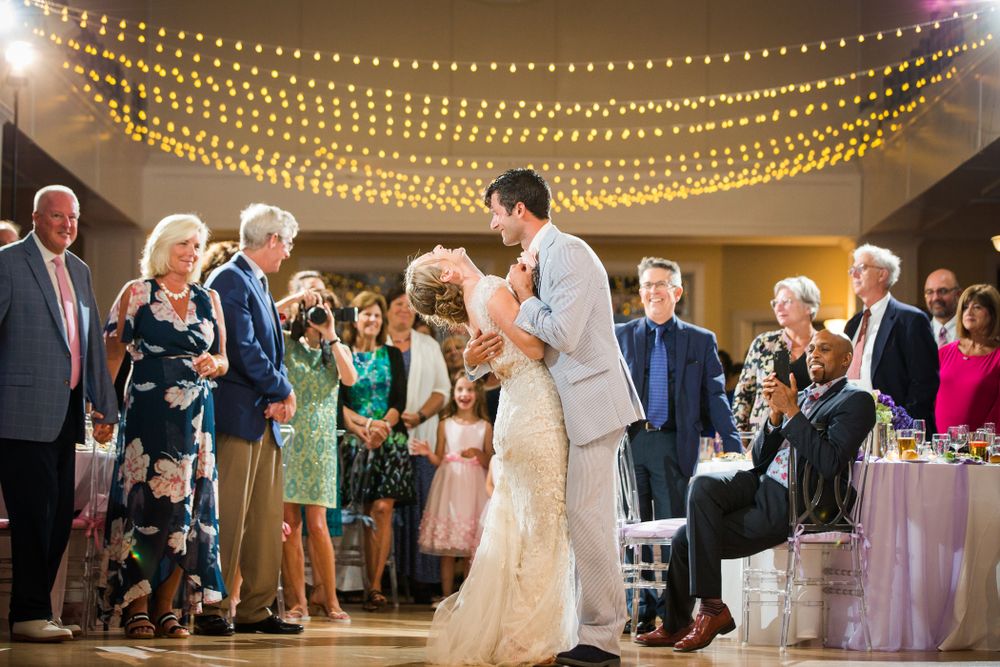 Wedding reception dance floor with string lights creating magical ambiance overhead.