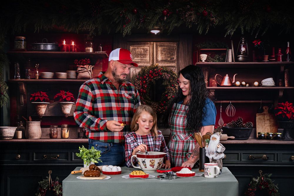 Family gathering around holiday dinner table in warmly lit rustic setting.