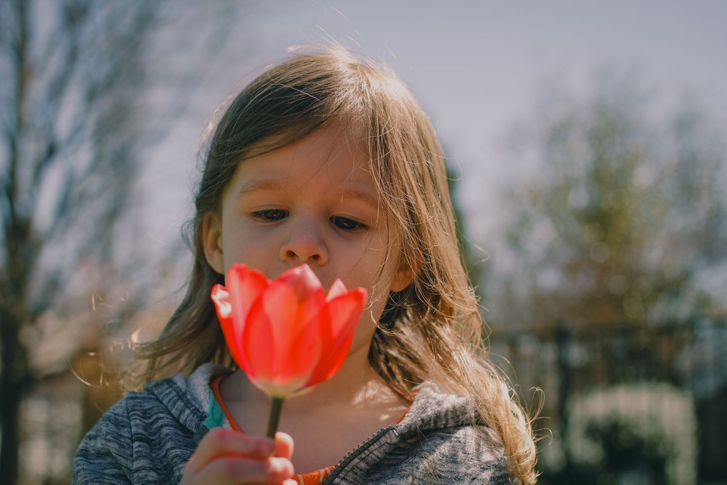 child smelling a flower