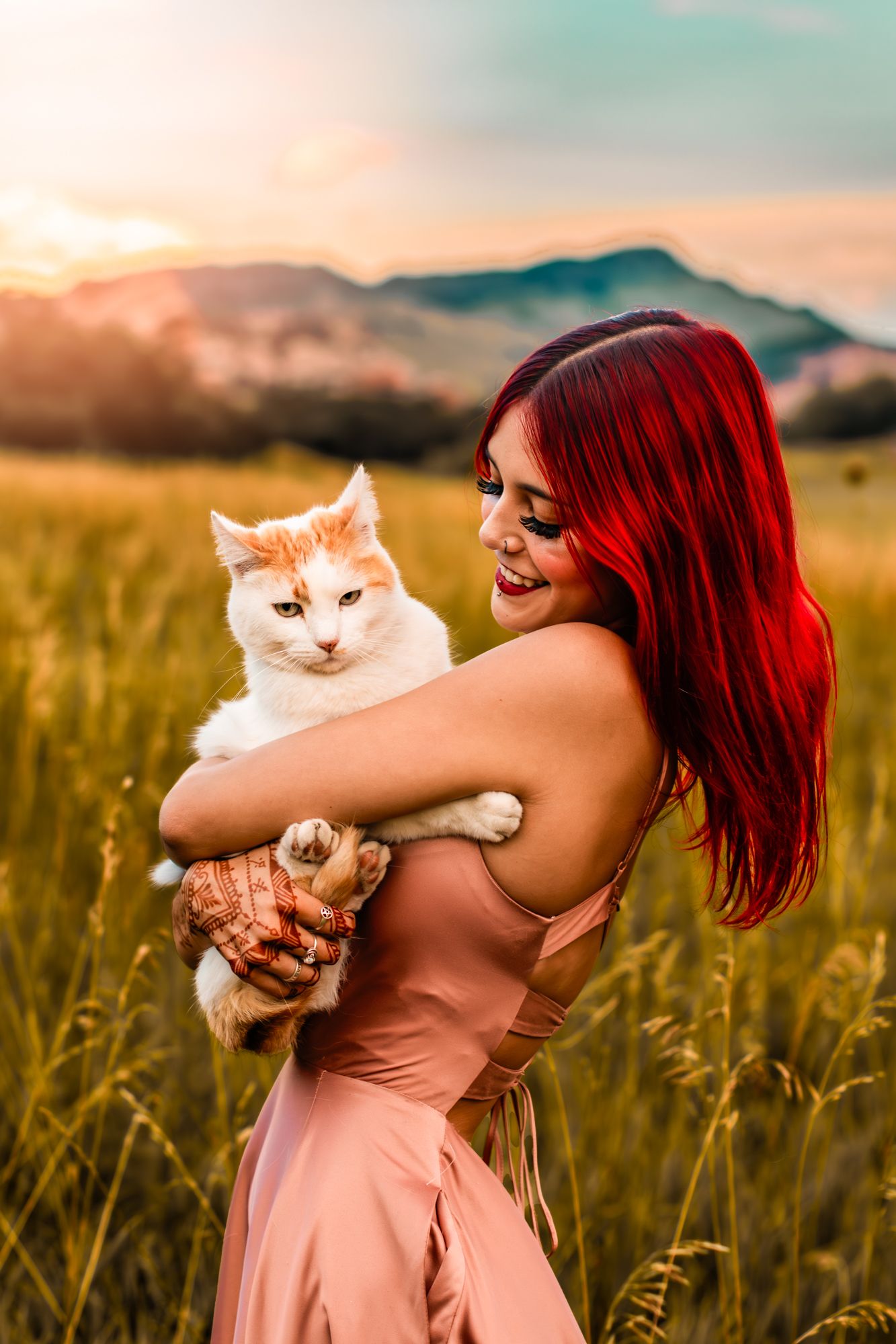 high school senior girl posing with her cat for senior portraits