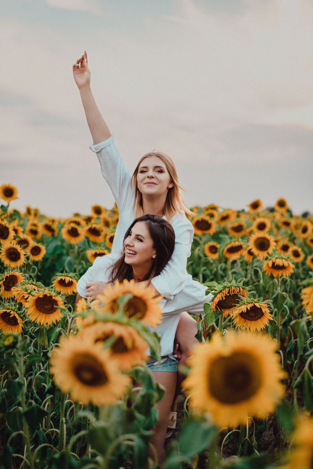 Candid moments captured in a sunflower field during golden hour.