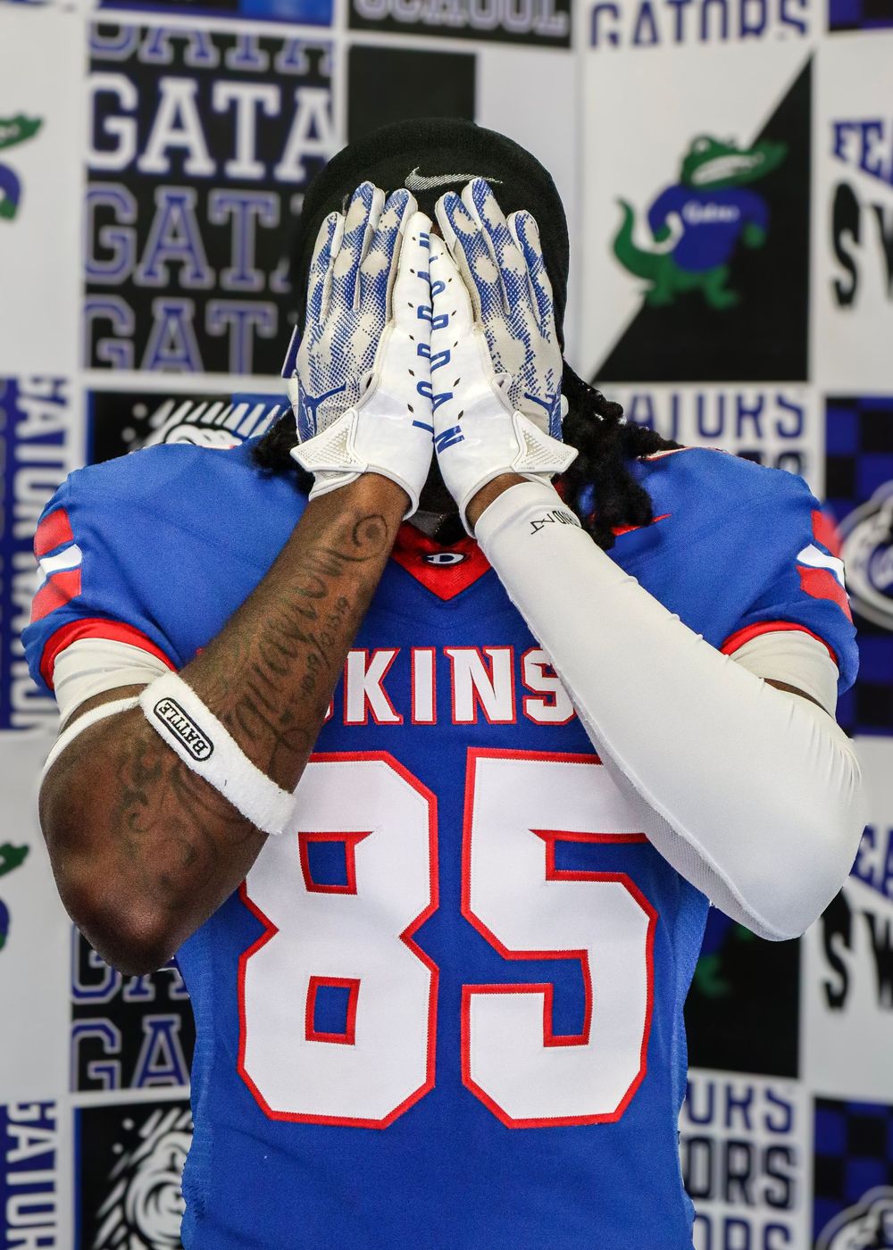 Players display white football gloves with anchor designs in Florida Gators uniforms.