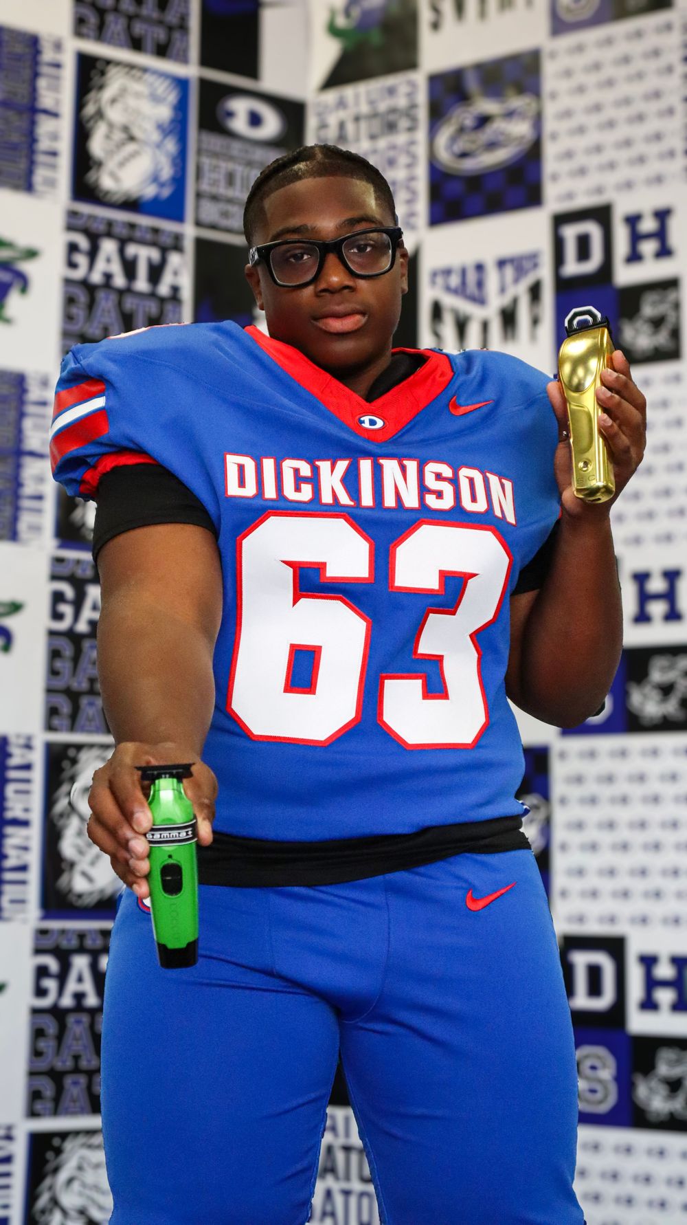 Football players in blue uniforms hold up sports drinks during team photo session.