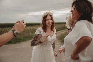 Joyful wedding celebration moment captured outdoors with guests sharing laughter.