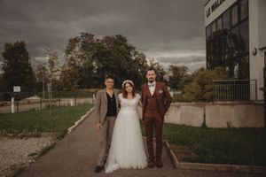Wedding party standing outside Le Waldeck building on an overcast day.