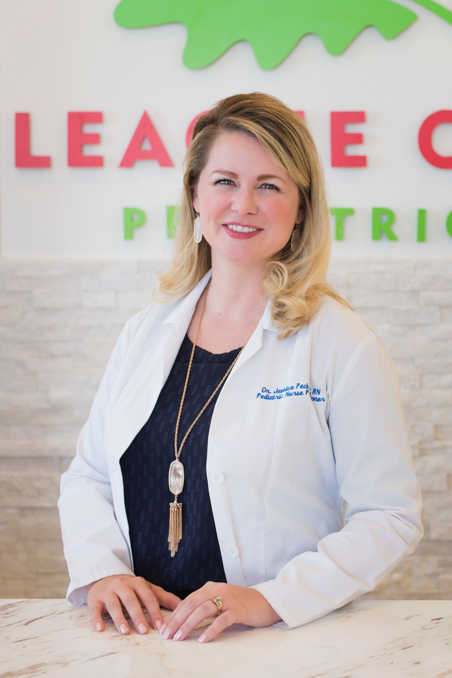 headshot of smiling nurse practitioner in a medical office