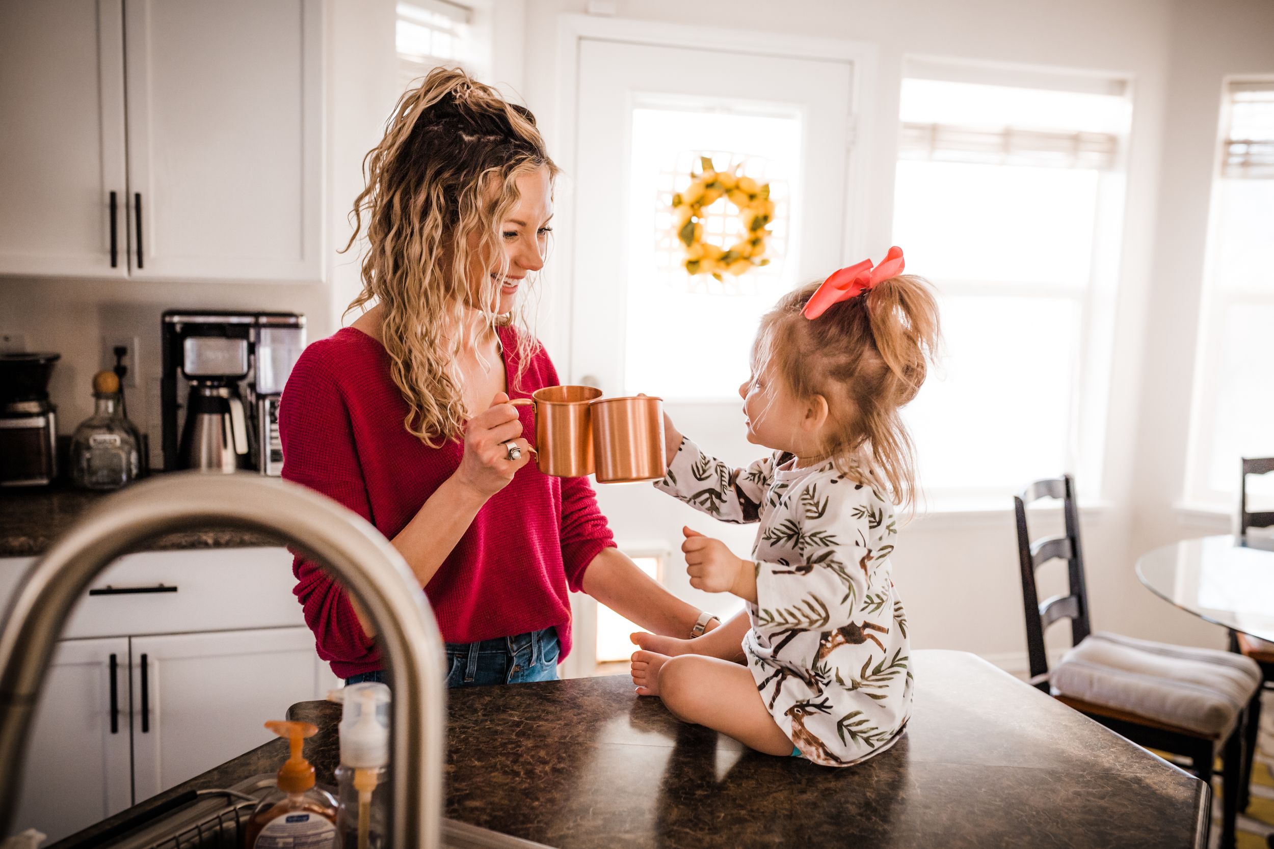 A mother and young daughter share a tender moment together while in kitchen. Whitney Popp Arizona photographer.