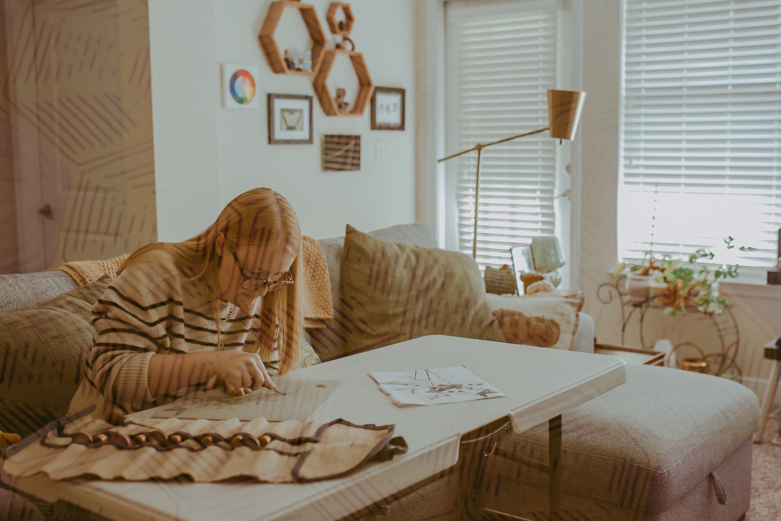 Woman sits at table creating stamps in her living room. Small business branding, Whitney Popp, Phoenix Arizona photographer.