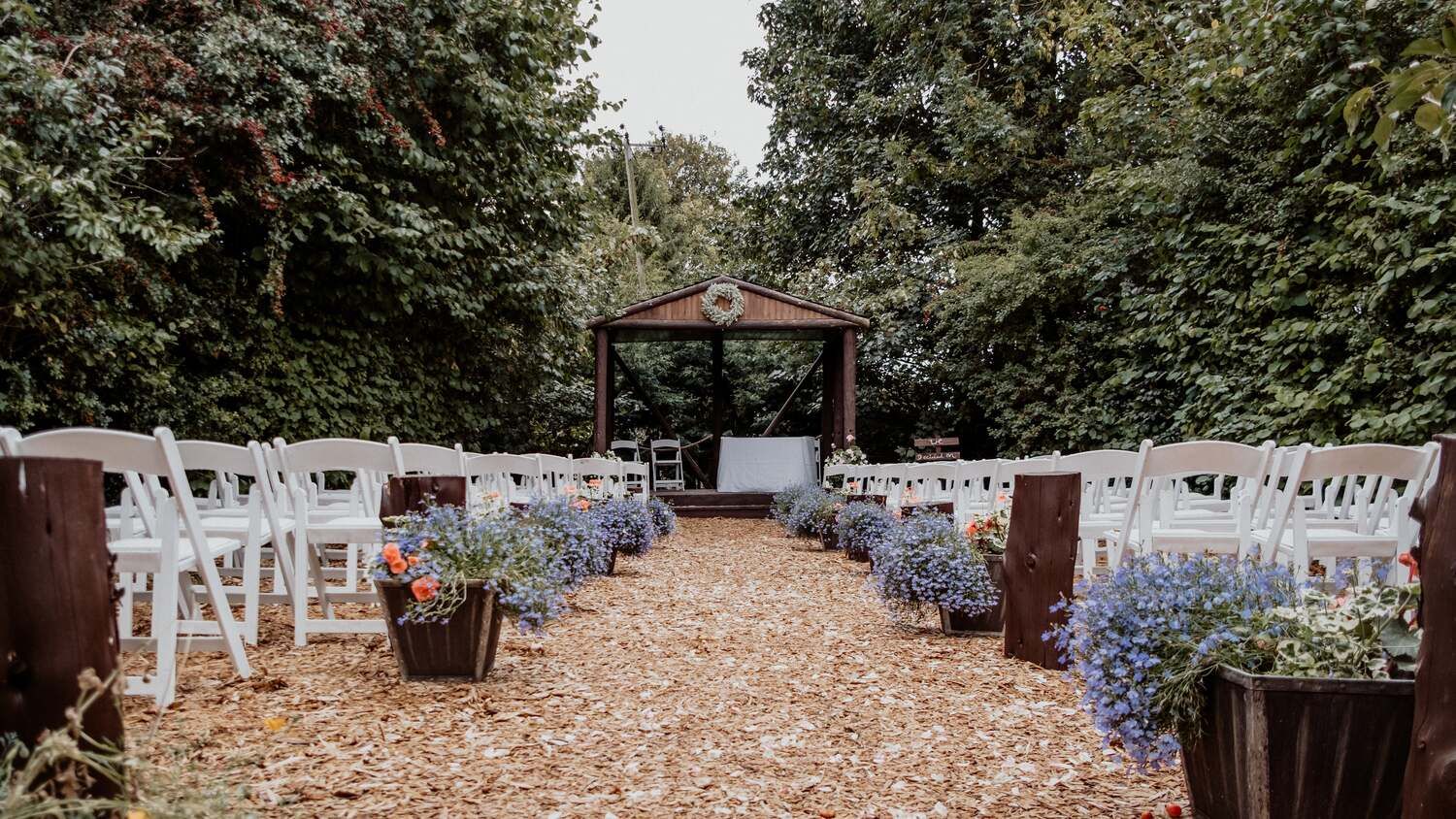 Outdoor wedding aisle the Wroxeter Hotel, white decorated seats