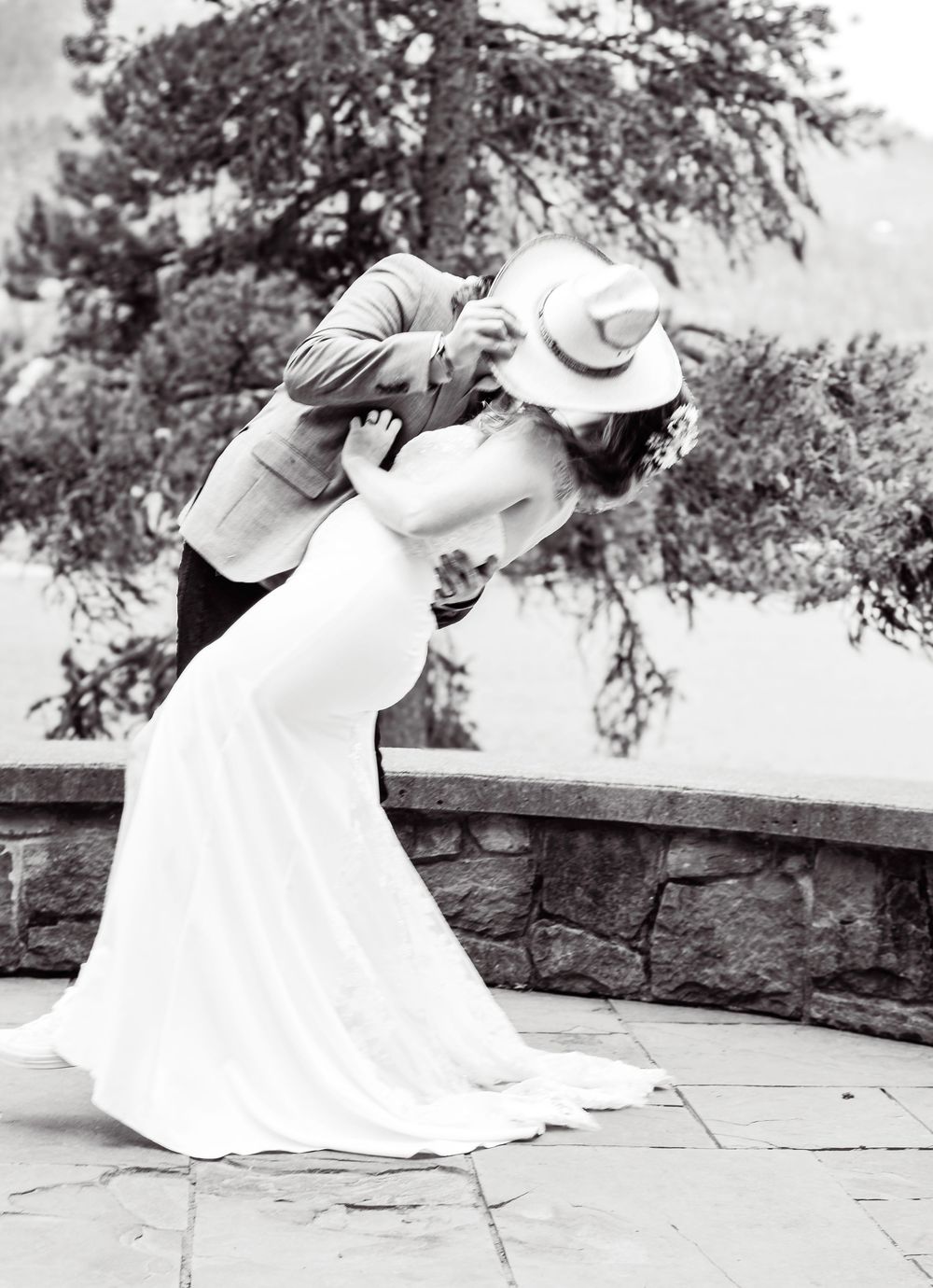 A black and white sequence showing someone in a wedding dress dipping down to inspect something on the ground.