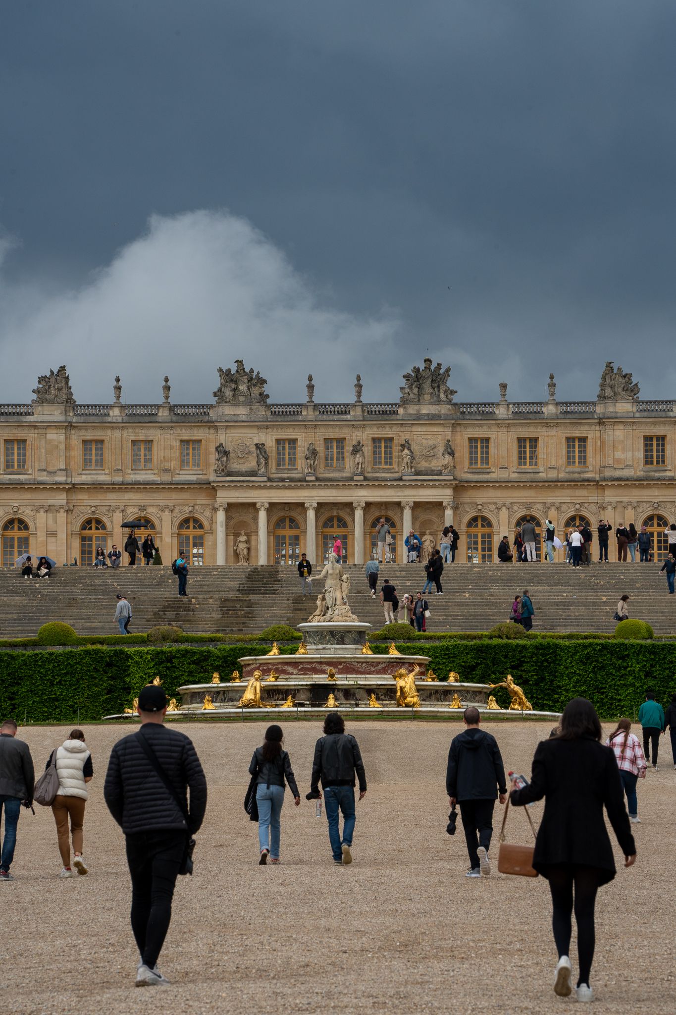Historic palace facade with ornate architecture and fountain in foreground.