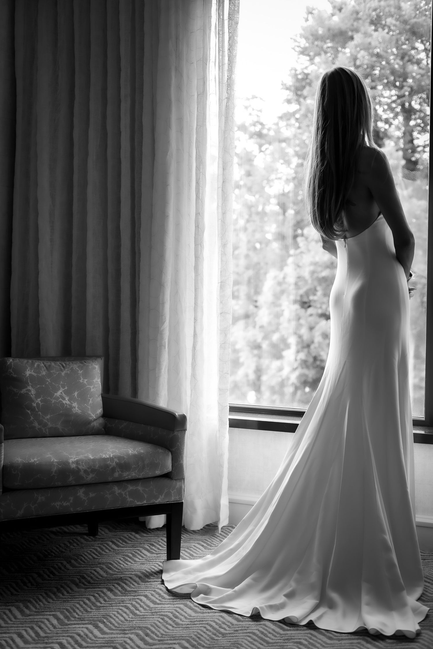 black and white portrait of bride at window