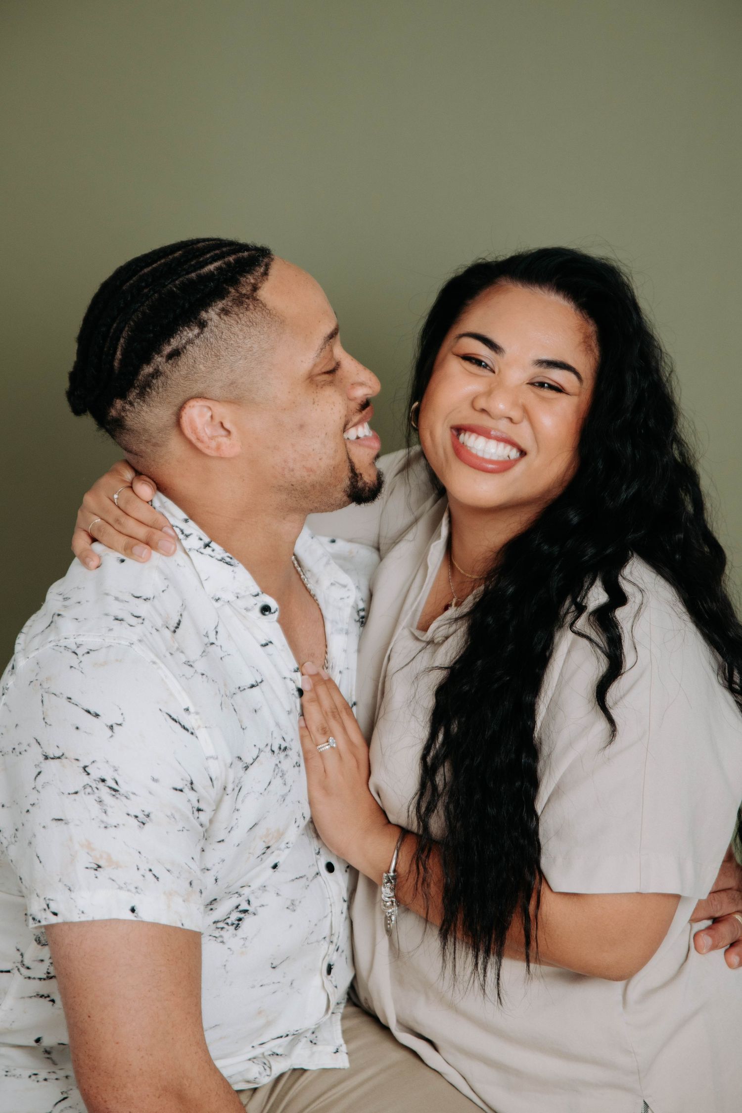 A candid moment of laughter between two people in a studio setting.