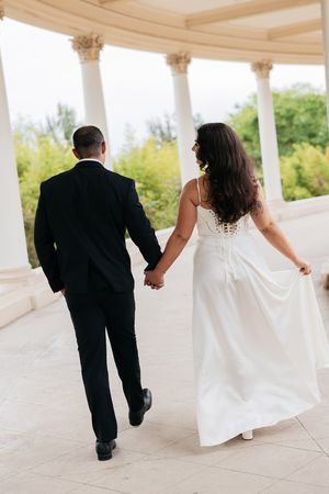 A sequence of wedding photos shows a couple walking along a white columned portico with flowing dress trailing behind.