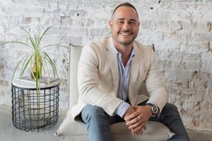 A series of images showing a modern office interior with exposed brick walls, plants, and business casual attire.