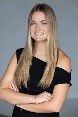 Professional studio portraits showing different poses against a gray background wearing a black sleeveless top.