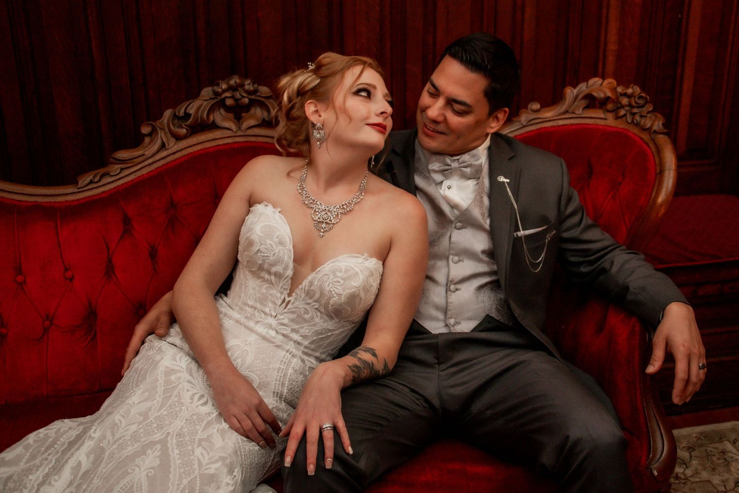 Bride and groom photo on red sofa