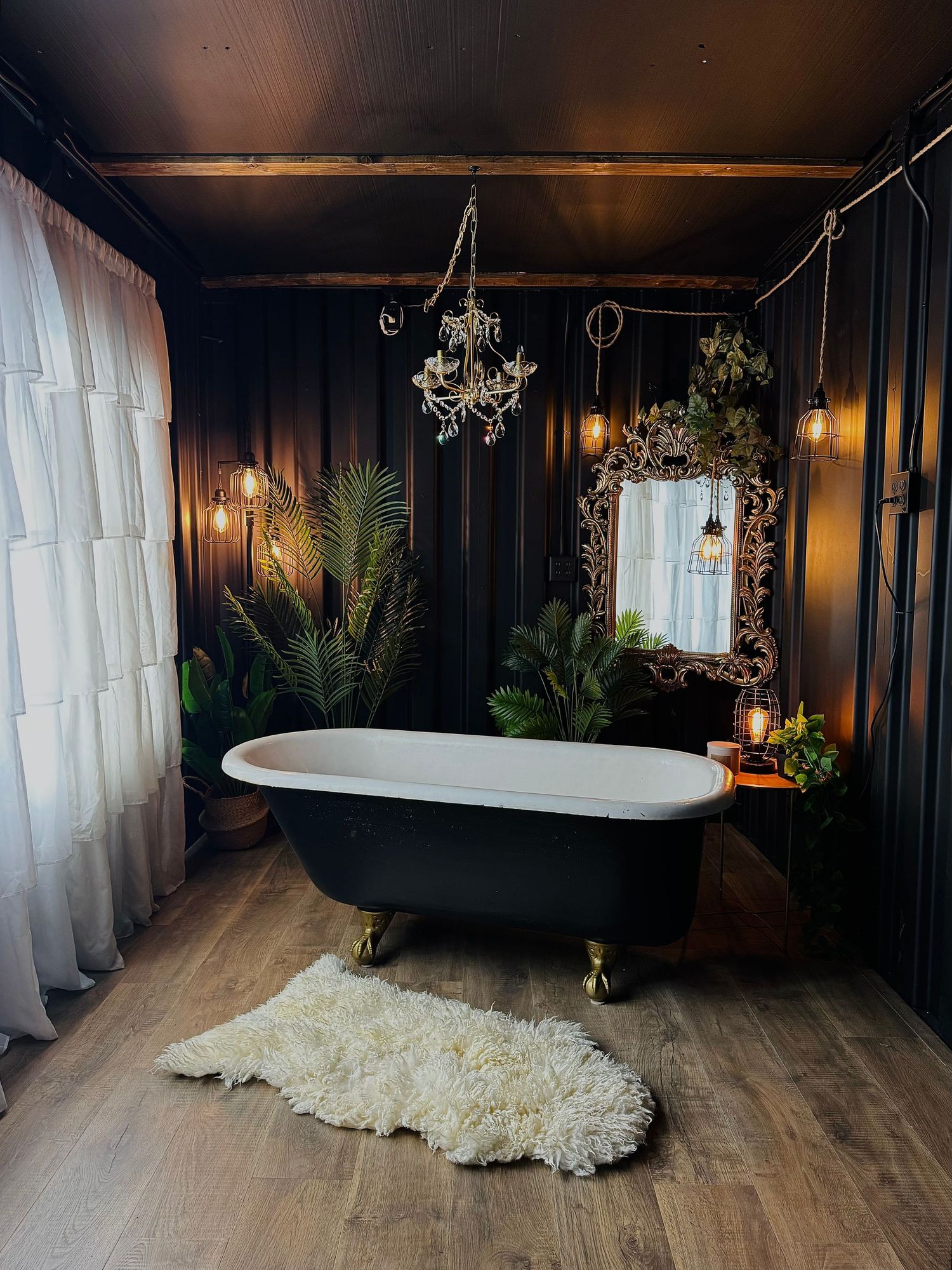 clawfoot bathtub boudoir photography in moody studio setting