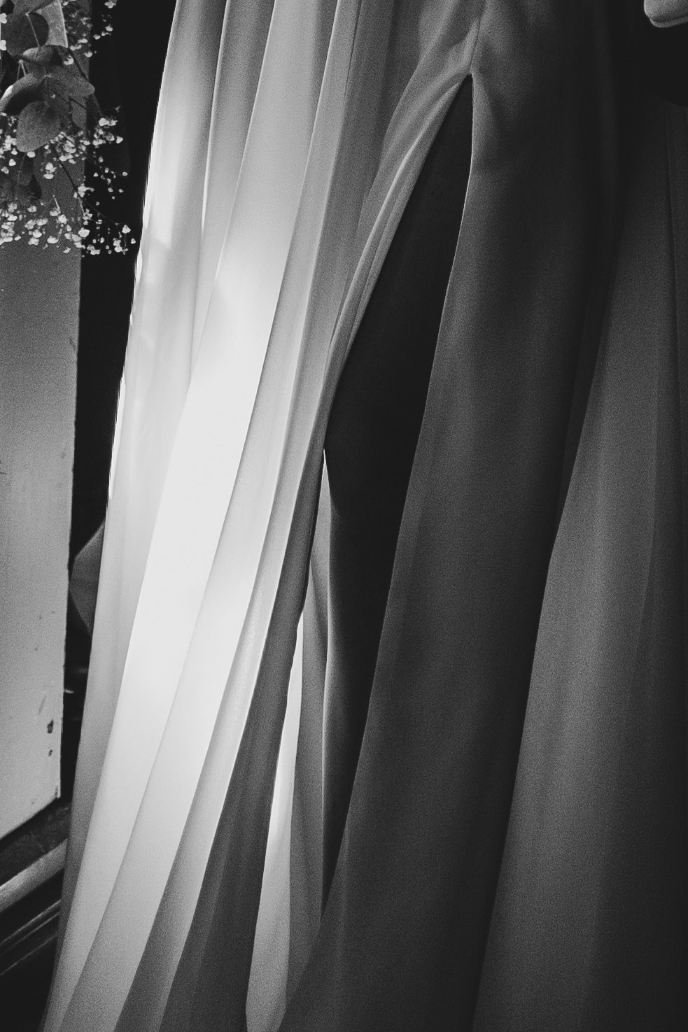 Abstract black and white composition of flowing fabric in vertical lines.