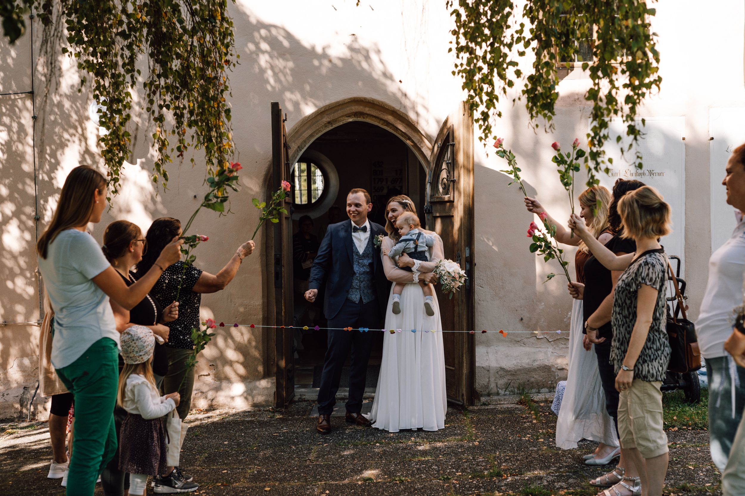 Outdoor wedding venue with birch trees and natural lighting.