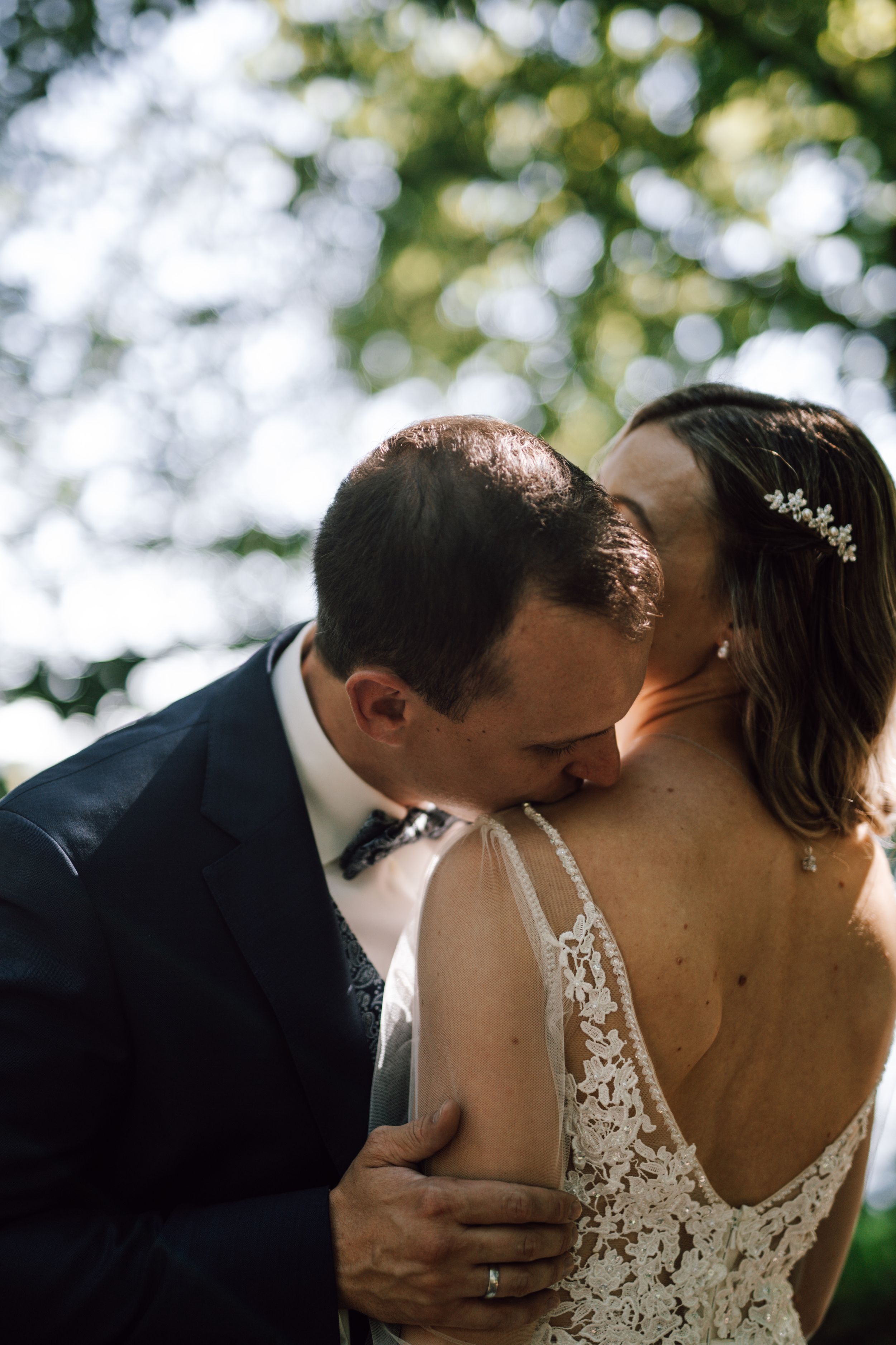 Intimate wedding portraits showing tender moments between newlyweds in natural lighting.