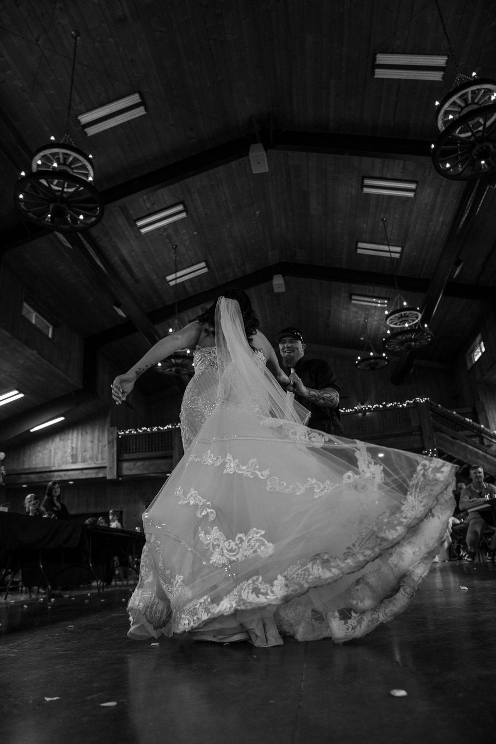 A black and white photo sequence captures the flowing movement of a white wedding dress during a dance performance.