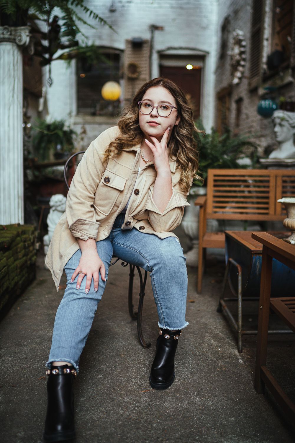 Casual portrait in urban setting wearing denim jacket and boots.