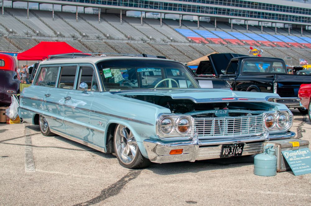 Classic light blue Chevrolet Impala station wagon on display at an outdoor car show.