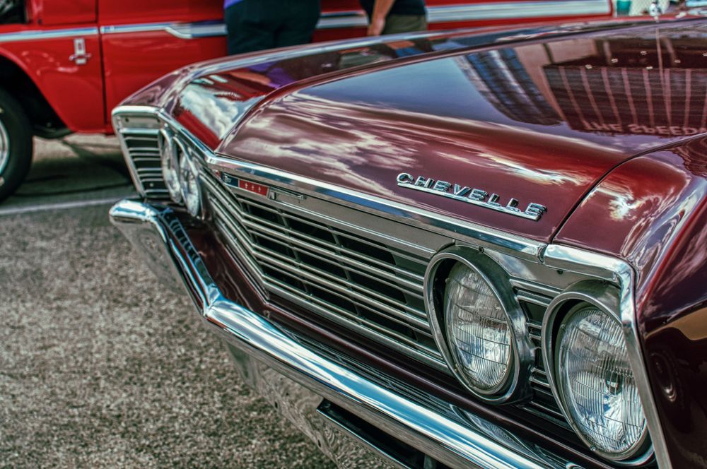 Front end detail of classic Chevrolet showing chrome grille and dual headlights.