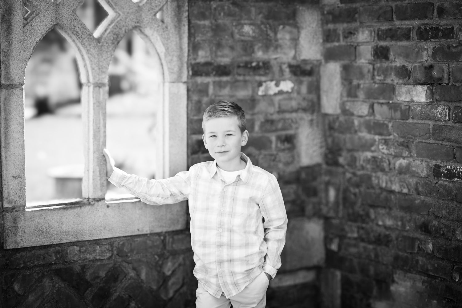 Young boy leaning against window in Wheatfield, Indiana.